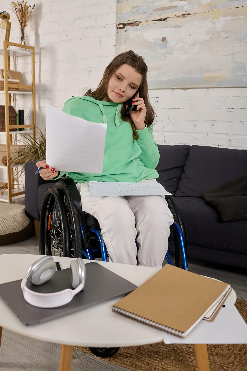 young-woman-in-wheelchair-reviews-documents-at-hom