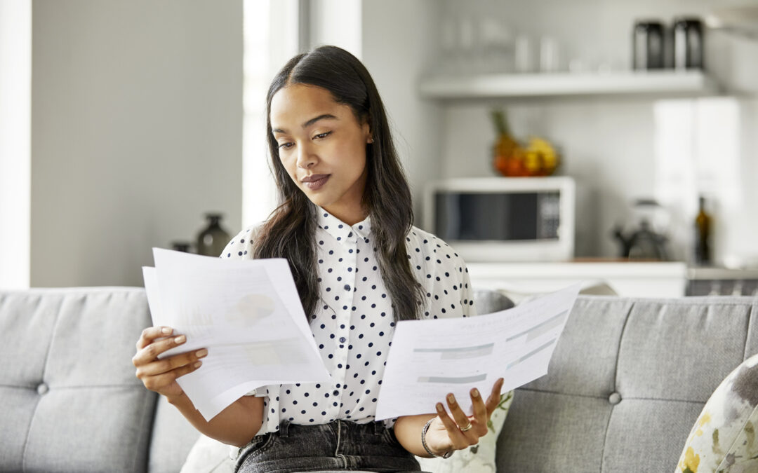 Woman analyzing financial documents at home