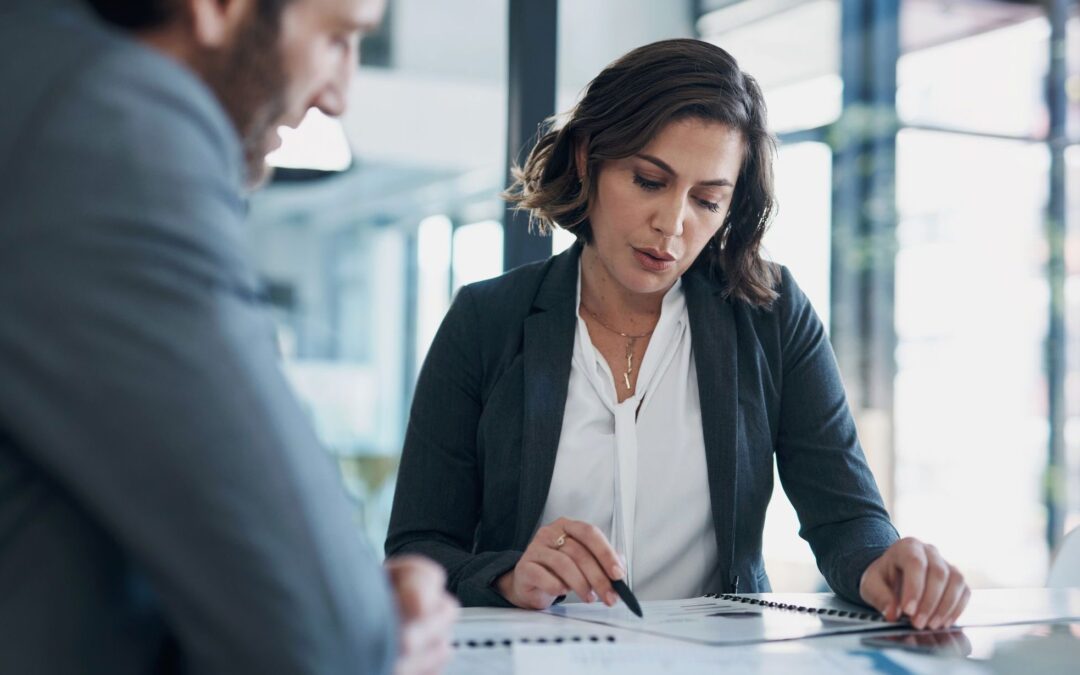 Business man, woman and paperwork with discussion for deal, agreement and proposal for b2b collaboration. People, staff and meeting with documents for financial strategy, stats and feedback in office