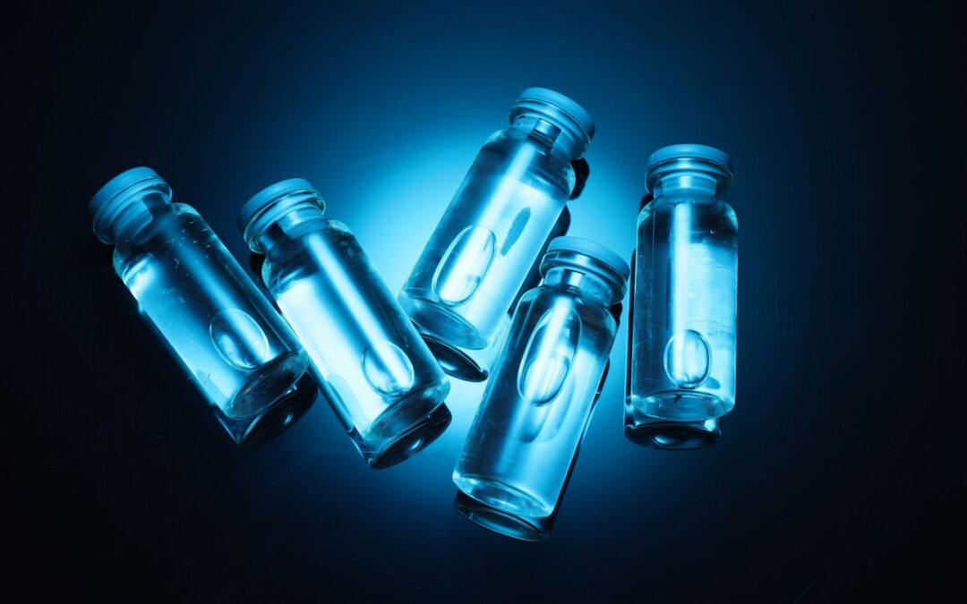 Glass peptide vials glowing in blue light